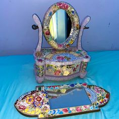 an elaborately decorated vanity and mirror on a blue background