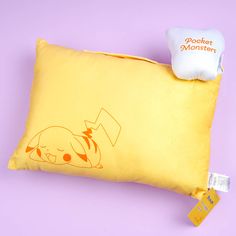 a yellow pillow with an image of a dog on it and a tag attached to it