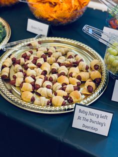 a table topped with lots of food on top of a metal tray