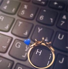 a ring on top of a computer keyboard with the letter h in front of it