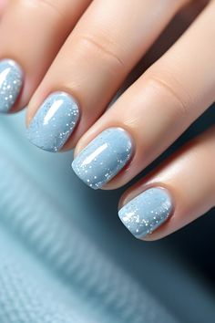 a woman's hand with blue and white nail polish