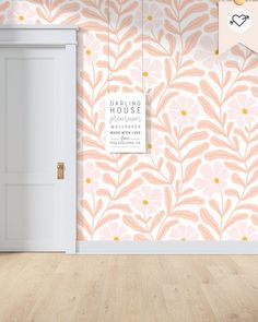 an open door in front of a pink floral wallpaper