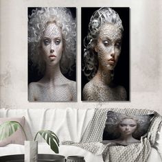 two paintings on the wall of a living room with white furniture and a coffee table