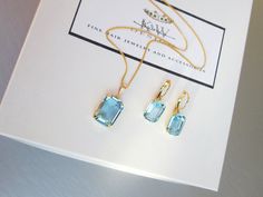 "This elegant matching jewelry set is made with the fancy emerald cut transparent Swarovski crystals in beautiful light blue color. The set is available in gold, silver or rose gold finish. - The earrings measure 7/8\" long and 3/8\" wide - The chain necklace measures 18\" long and the pendant is 1\" tall" Light Blue Emerald Cut Jewelry For Wedding, Emerald Cut Light Blue Jewelry For Weddings, Light Blue Emerald Cut Wedding Jewelry, Elegant Blue Topaz Octagon Jewelry, Elegant Octagon Blue Topaz Jewelry, Elegant Light Blue Faceted Jewelry, Blue Rectangular Faceted Jewelry, Elegant Octagon Aquamarine Jewelry, Emerald Cut Aquamarine Gold Jewelry