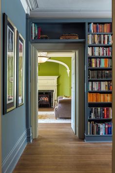 an open door leading to a living room filled with books