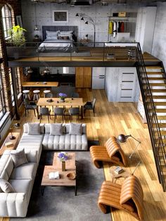 an aerial view of a living room with couches, tables and stairs in it