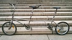 a bicycle parked on the side of some steps in front of an empty bleachers