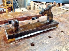 a pair of woodworking tools sitting on top of a wooden table in a shop