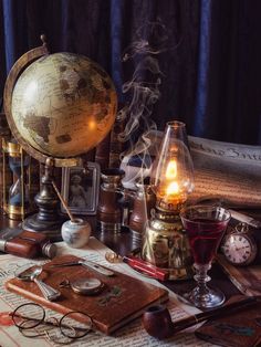 a table topped with books, glasses and an old fashioned globe on top of it