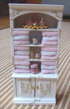 there is a small cabinet with towels on it