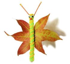 a butterfly made out of leaves on top of a cell phone screen with the caption's name below it