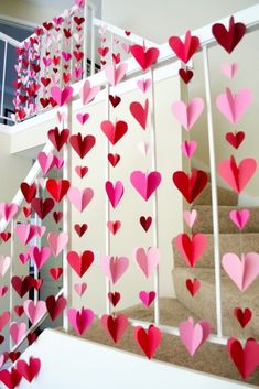 paper hearts are hanging from the banister