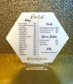 the price list for an event is displayed in front of a gold glittered wall