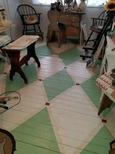 a room with green and white checkered flooring next to a table in the corner