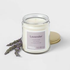 the lavender candle is next to a coaster