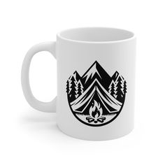 a white coffee mug with mountains and trees on it