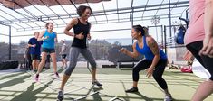 a group of women running across a tennis court