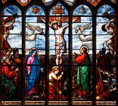 a stained glass window depicting the crucifixion with jesus and other people