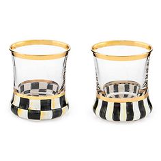 two glass cups with gold rims and black and white checkerboard pattern on them