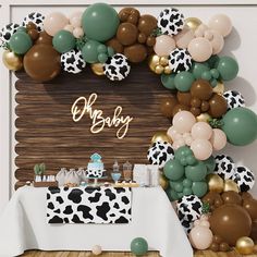 a baby shower is decorated with balloons and cow print