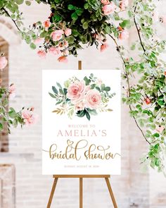 an easel with flowers and greenery on it for a bridal shower sign