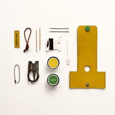 sewing supplies are laid out on a white surface, including scissors, thread, tape and other items