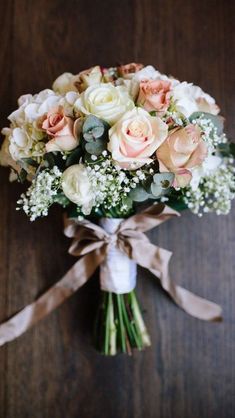 a bouquet of flowers is tied up on a table