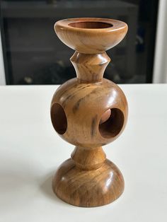 a wooden candle holder sitting on top of a table