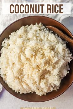 coconut rice in a brown bowl with a wooden spoon on the side and text overlay