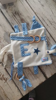 a blue and white bag sitting on top of a wooden table next to a pair of shoes