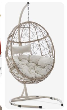 a white hanging chair with pillows on it and some other items in front of it