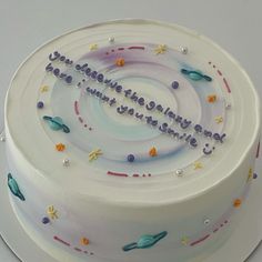 a birthday cake that is decorated with stars and confetti on the top layer