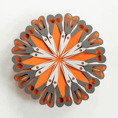 an orange and silver plate with scissors on it