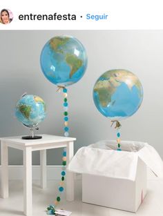 two blue and green globe balloons in a room