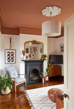 a living room filled with furniture and a fire place next to a mirror on the wall