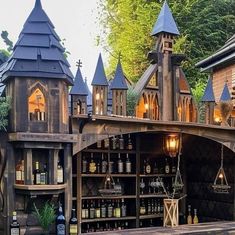 an outdoor bar with lots of bottles and lights