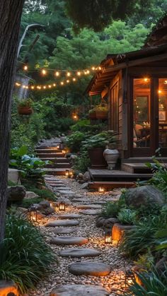 a stone path leads to a house with lights strung from the roof and around it