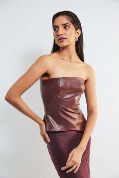 A leather corset top paired with a maxi skirt in lycra in a rich wine color creates a bold and edgy ensemble making it a stunning outfit. Red Corset And Skirt, Corset Top And Skirt, Red Corset Top, Leather Corset Top, Corset And Skirt, Red Corset, Heel Accessories, Top And Skirt Set, Leather Corset