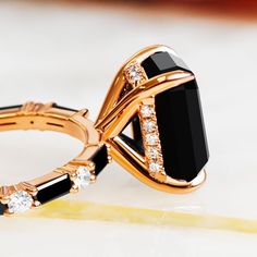 a black and gold ring with diamonds on it