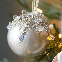 a white ornament hanging from a christmas tree