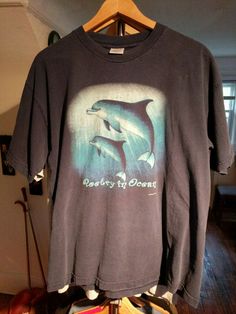 Vintage Dolphin T Shirt Made In USA Cetacean Poetry In Ocean XL. Shipped with USPS First Class Package. Condition is very good.100 percent cotton.  Little cracking on graphic print  See photo. Slight fading on the navy blue. Comes from the smoke and pet-free home. Fast shipping. Trusted eBay seller. Dolphin Shirt, Poetry Fashion, Outfit References, Bouncy Balls, The Navy, Dream Clothes, Ebay Seller, Pretty Cool, 100 Percent