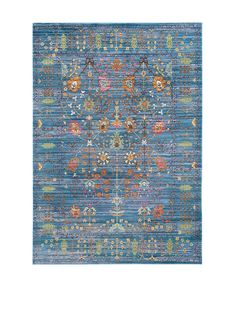 a blue rug with an ornate design on the top and bottom, in different colors