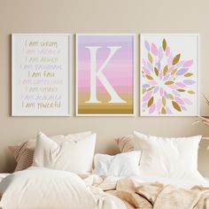 three framed art prints on the wall above a bed