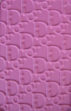 a close up view of the bottom part of a pink case with letters on it