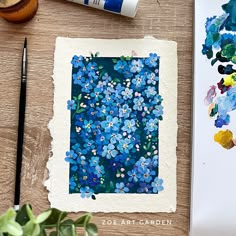 an art project with blue flowers and watercolor paints