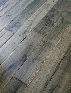 an image of wood flooring with the words by exquisite surfaces