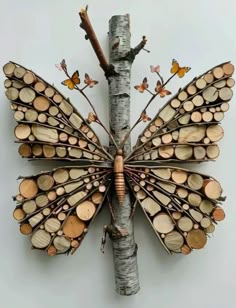 a butterfly made out of wood sitting on top of a tree