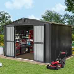 a small metal shed with the door open and lawn mower in front of it