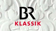 the letter klasssk is placed in front of a white wall with red and black designs