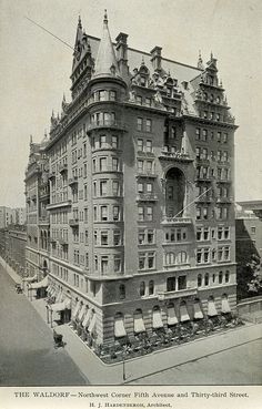 an old black and white photo of a large building with many windows on the top floor